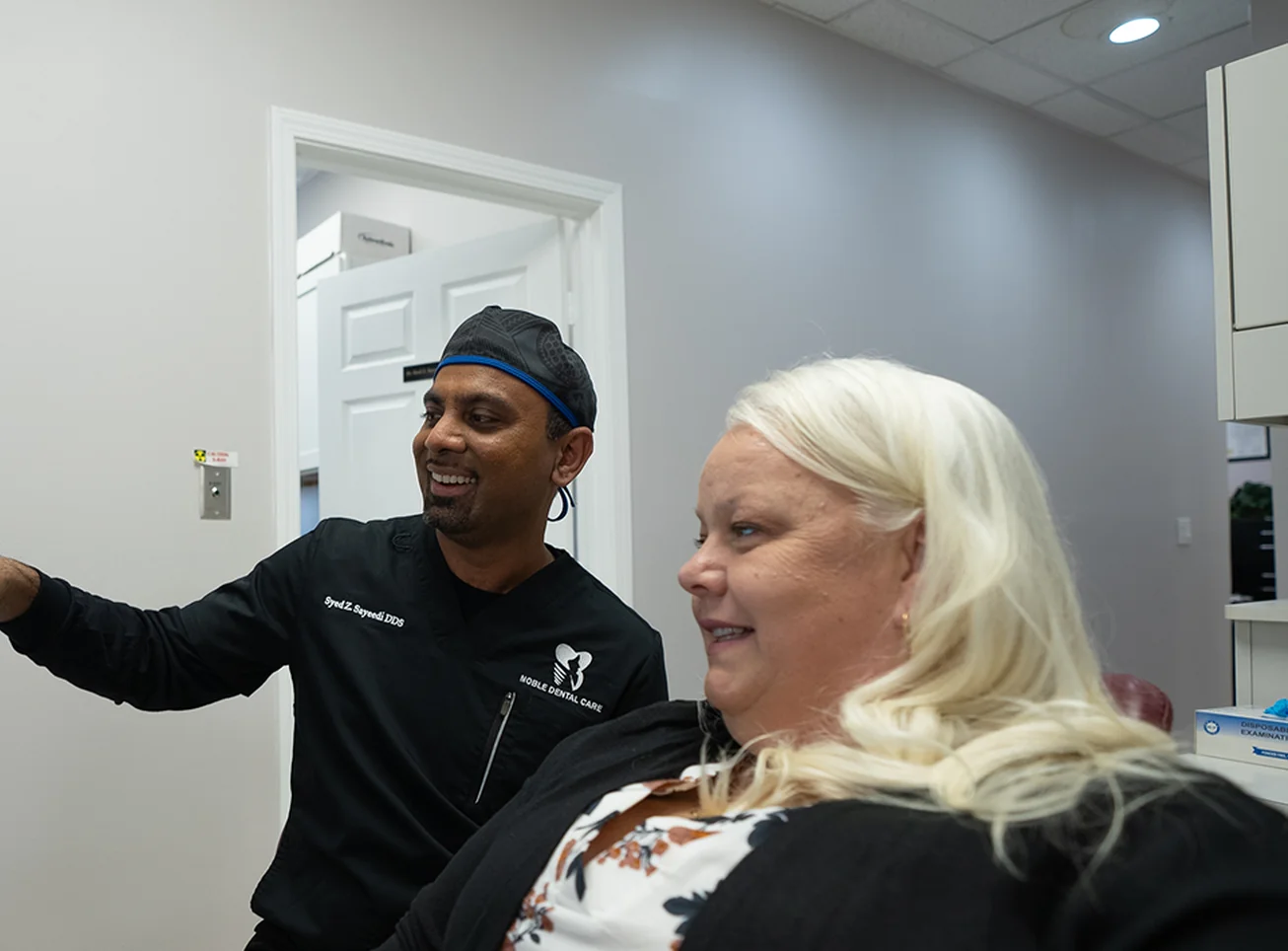 Dr. Sayeedi talking with a patient at Noble Dental Care